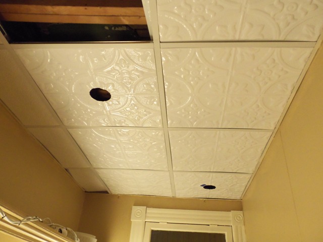 The light fixture will go in the nearer hole.  The farther hole is the mistake tile.