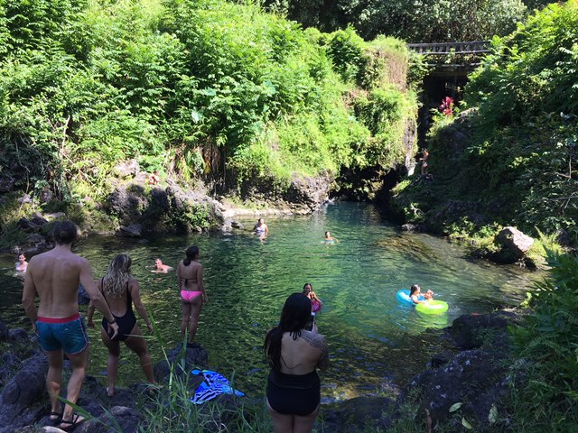 The girl in the right side of the picture is about to jump into the water.  No one jumped from the higher spot while we were there.